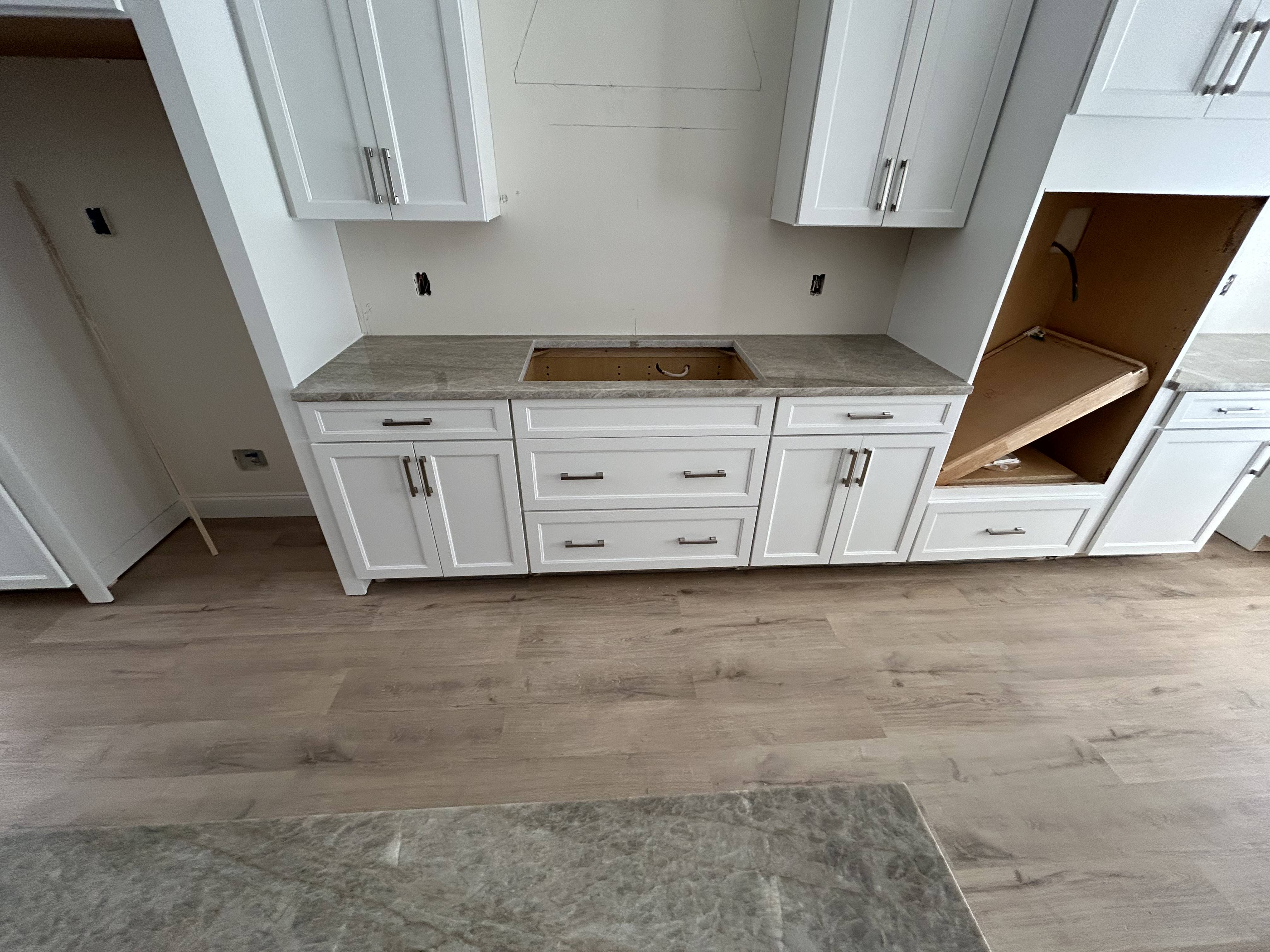 White cabinetry with gray-veined countertops